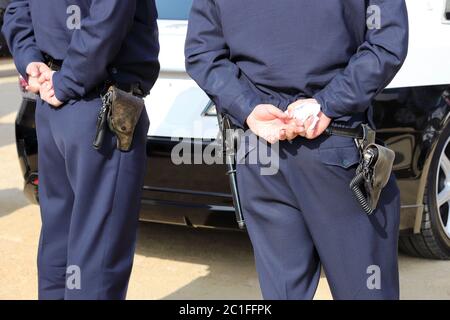 Back view of Japanese police officer, with patrol car Stock Photo