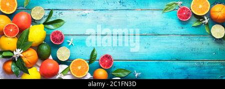 Assorted Fresh Citrus Fruit On Wooden Table - Lemon Orange Lime In Top View Stock Photo