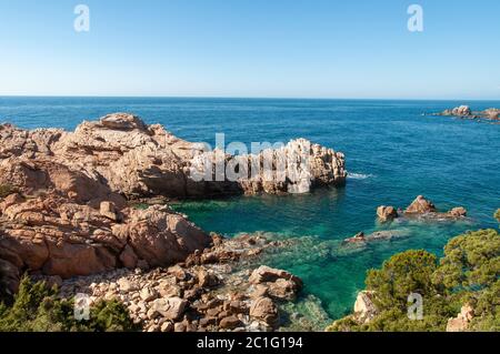 Rock pink granitic formation at Costa Paradiso beach in Sardinia Italy with turquoise blue sea Stock Photo