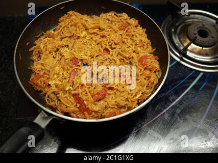 Vegetable Maggie Noodles, Photo of cooking Fry Pan instant noodles . Stock Photo