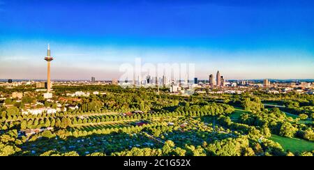Beautiful aerial view on european finance center city Frankfurt am Main downtown skyline in spring.  Blue sky, clouds, green trees. Hesse, Germany. Stock Photo