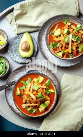 Mexican style table with spicy aztec soup with fried tortilla. Sopa azteca Stock Photo