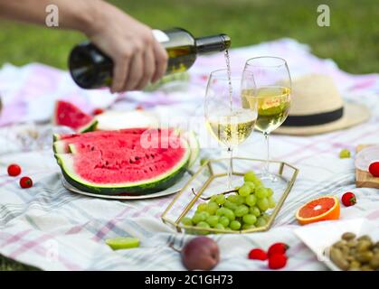 Picnic with white wine on green grass Stock Photo