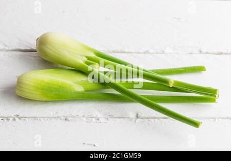 Fresh fennel isolated on white rustic wooden table Stock Photo