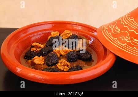 Moroccan food. Typical Clay tajine with lamb and dried fruits. Stock Photo