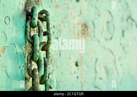 Chain at a steel door on an abandoned company site Stock Photo
