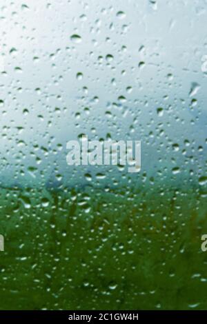 Natural background Drops on both sides of the glass from the rain and from the fogging abstract view, raindrops against the blue Stock Photo