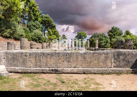 Olympia, Greece - September 7, 2014: Tourists are passing by Ruin of temple of Hera, Heraion in Olympia, Greece Stock Photo