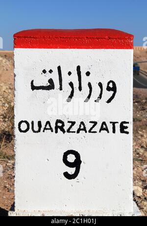 Ouarzazate 9 kilometers - roadside distance indicator National route between Ouarzazate and Marrakesh, Morocco. Stock Photo