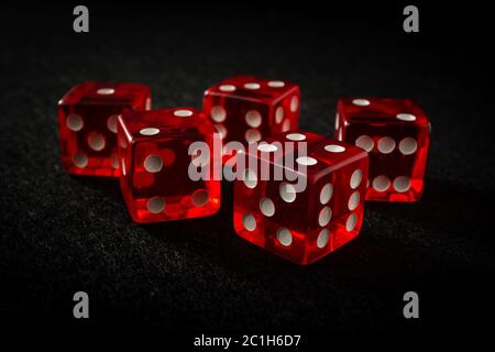 red dice on black felt Stock Photo