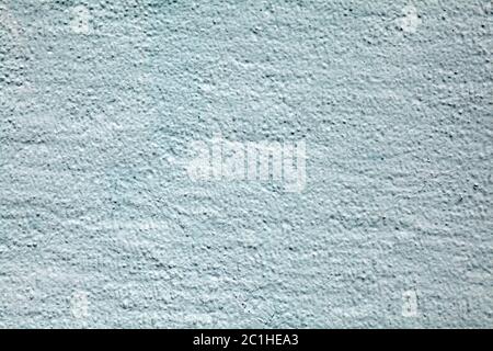 The texture of the wall with rough stucco is light blue. Abstract background plastered surface. Stock Photo