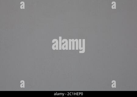 Fine-grained texture of gray color on a plastered wall. Abstract background of painted rough stucco. Stock Photo