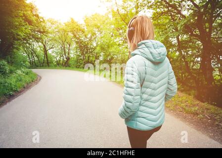 Attractive blonde girl wearing Running tight leggings jogging in