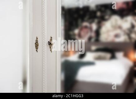 Antique vintage mirror on closet with golden lock and key in bedroom Stock Photo