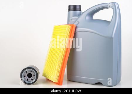 Filters and a container with oil for a passenger car. Maintenance accessories for vehicles for private use. Light background. Stock Photo