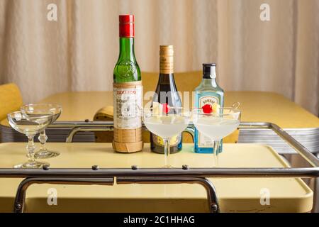 Classic cocktail, Aviation with liquor bottles on vintage bar cart Stock Photo