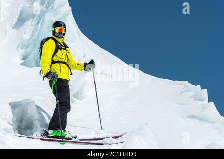 A freerider skier in complete outfit stands on a glacier in the North Caucasus Stock Photo