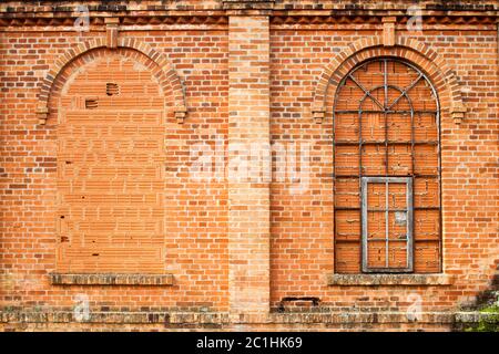 Closed windows in old orange brick wall Stock Photo