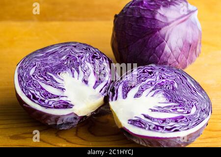 Purple cabbage isolated on wooden table close up Stock Photo