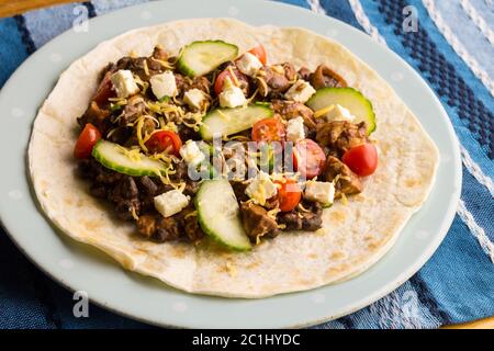 Tortilla with chicken, cheese and fresh vegetables closeup Stock Photo