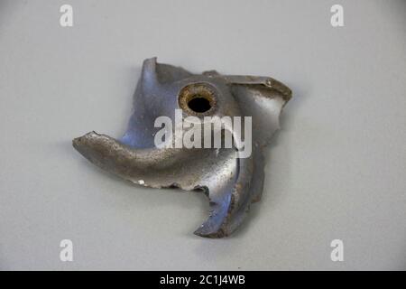Impeller of a water pump. The impeller is heavily worn by stones ...
