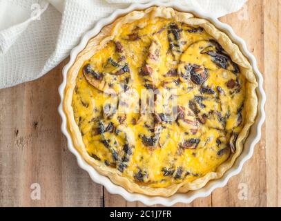 Mushroom quiche close up on wooden table - top view photo Stock Photo