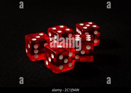 red dice on black felt Stock Photo