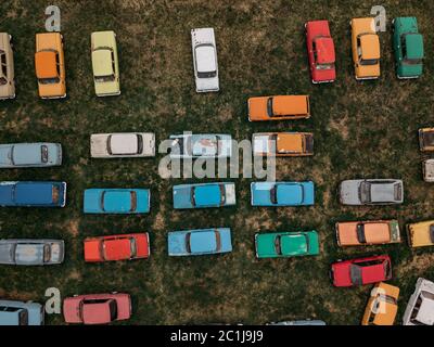 Old rusty abandoned retro cars, aerial top view from drone. Stock Photo