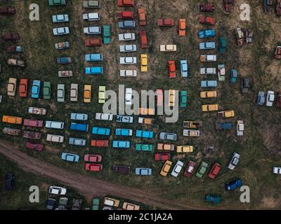 Old rusty abandoned retro cars, aerial top view from drone. Stock Photo