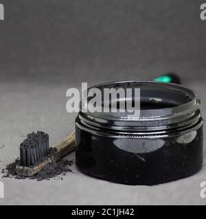 Charcoal on a toothbrush to whiten teeth Stock Photo