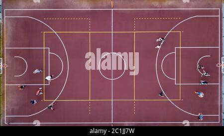 Basketball court with players and ball. Sports game in basketball. View strictly from above with the drone. Stock Photo