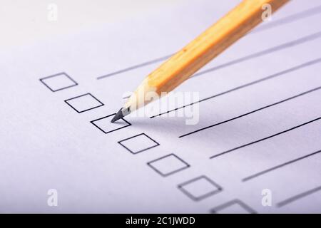 questionnaire on white paper with pencil Stock Photo - Alamy