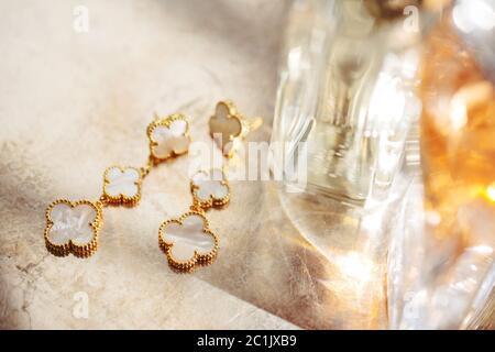 Silvery golden bracelet of brilliant decorative flowers for a special occasion lying on the table, selective soft focus. Stock Photo