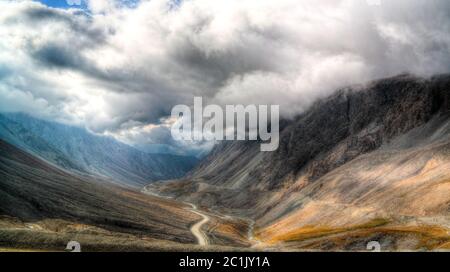 serpentine road to Barskoon pass, river and gorge and Sarymoynak pass, Jeti-Oguz, Kyrgyzstan Stock Photo