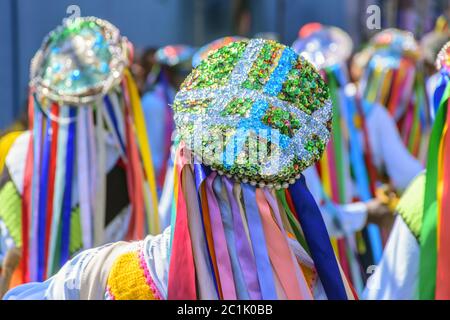 Men dressed in colorful clothes in a popular religious festival Stock Photo