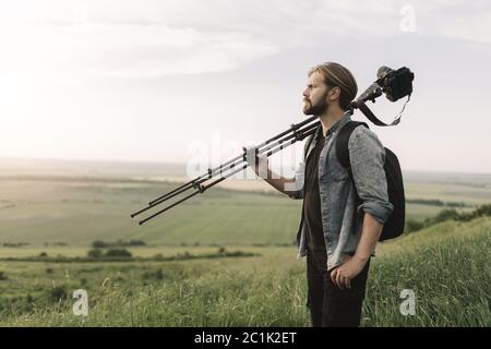 Bearded man using professional equipment for shooting nature Stock Photo