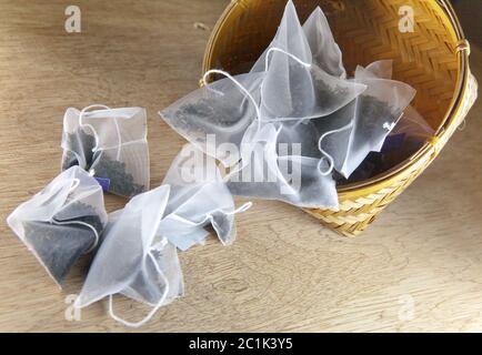 bags of elite tea in silk fabric packing on a wooden background Stock Photo