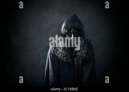 The witch in hooded cloak Stock Photo - Alamy