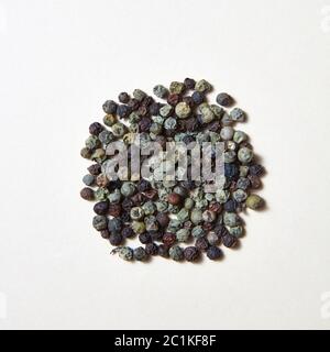 Spices pattern of different kinds of pepper -black, green on a white background . Stock Photo