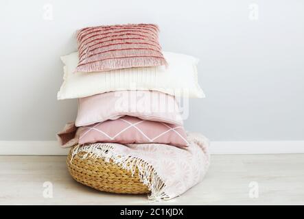 Pink and white pillows on the wall background Stock Photo
