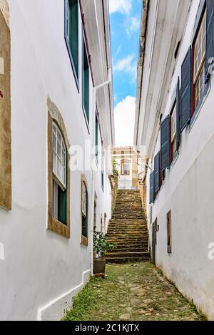 Old cobblestone street with houses in colonial style Stock Photo