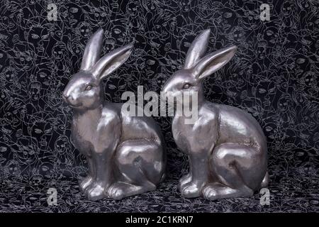 luxury metal easter bunnies in silver on dark background Stock Photo