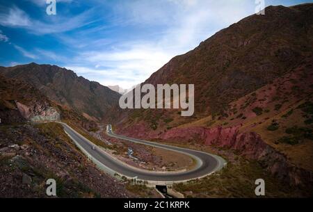 Serpentine road in Too-Ashuu pass and Kara Balta river and valley,Chuy Region of Kyrgyzstan Stock Photo