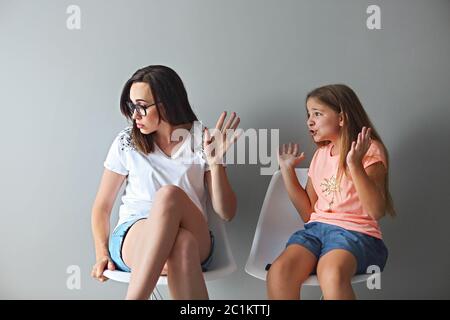 Furious young mother in a discussion with her teenage daughter Stock Photo