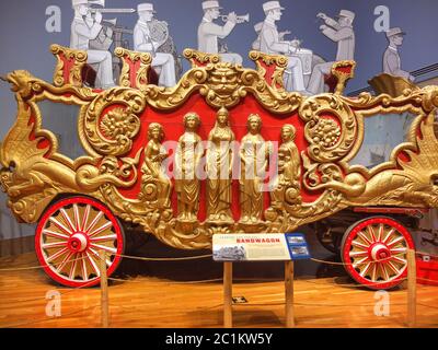 An 1878 gilded band wagon is exhibited at the John and Mable Ringling Museum in Sarasota, FL. The five carved figures represent Columbia and the Four Stock Photo