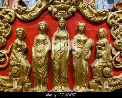 An 1878 gilded band wagon is exhibited at the John and Mable Ringling Museum in Sarasota, FL. The five carved figures represent Columbia and the Four Stock Photo