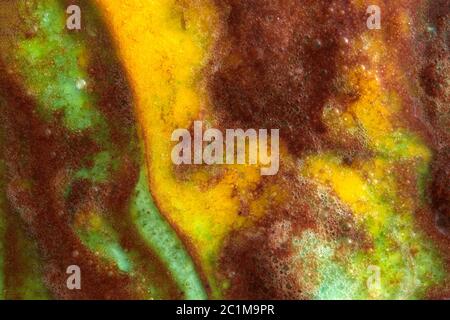 Background from melted ice cream in green and yellow tones. Close-up. Stock Photo