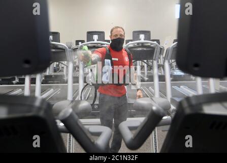 Maplewood United States 15th June Employee Matt Bohn Uses An Ultra Violet Light To Kill Bacteria On A Treadmill While Plexiglass Separates Machines At The Club Fitness Gym In Maplewood Missouri