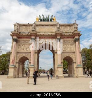 Paris, France, March 28 2017: Arc de Triomphe du Carrousel in front of the Tuileries Gardens seen from the courtyard of the Louv Stock Photo