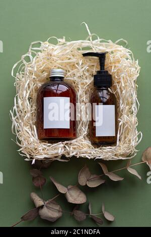 Natural organic SPA cosmetic products set with dry purple leaves. Top view herbal skincare beauty products on green background. Banner mockup for eco Stock Photo